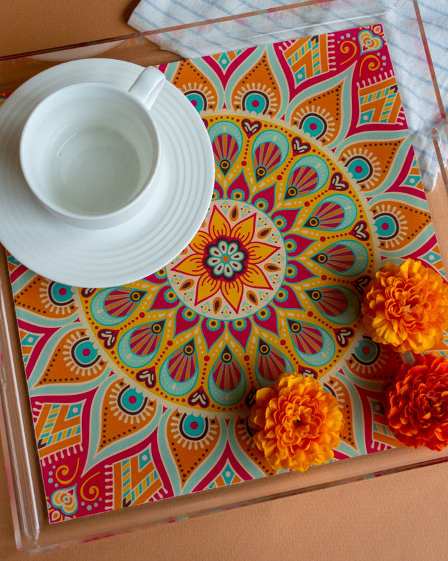 Colorful mandala-patterned tray with a white cup and saucer on a brown surface.