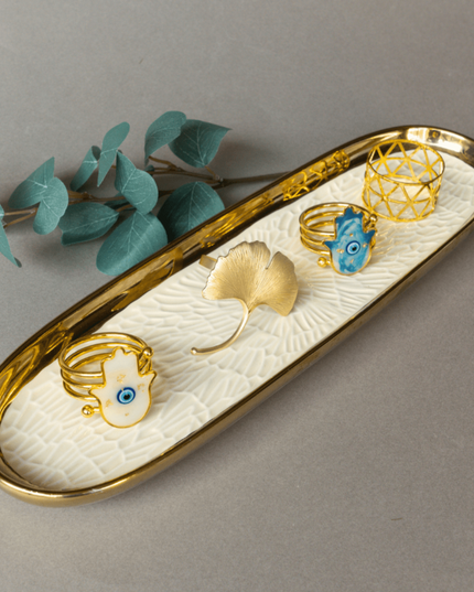 Porcelain tray with napkin rings on a gray background
