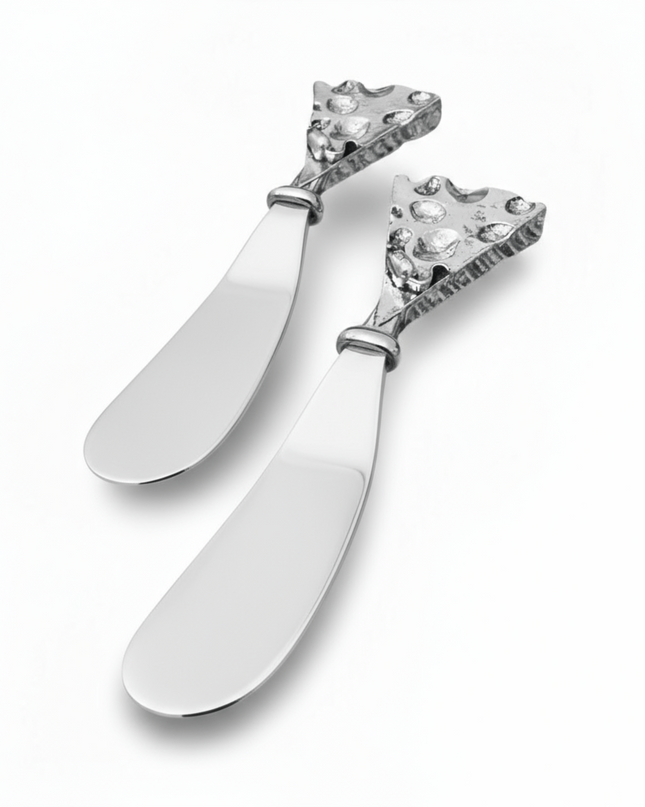 Two decorative hammered silver butter cheese knives with intricate designs on a white background