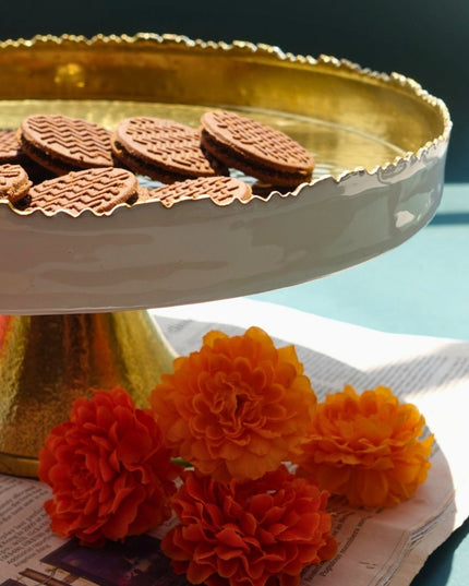 White and Gold Metal Cake Platter with cookies on a green background