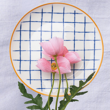 Casa Duniya's White Blue Checkered Bone China Zambila Dessert Plate with Pink Flower against White Linen Background
