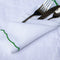 Casa Duniya's White Linen Placemat and Napkins with Green Scalloped Border and Chameli Hammered Silver Cutlery Set