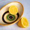 Casa Duniya's Hand-Painted Oval Yellow Evil Eye Bowls with Lemons against a White Linen Background