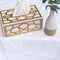 Casa Duniya's Hand-Painted White Gold Tissue Box Holder and Yahi White Beige Ceramic Holder with Leaves against a White Linen Table