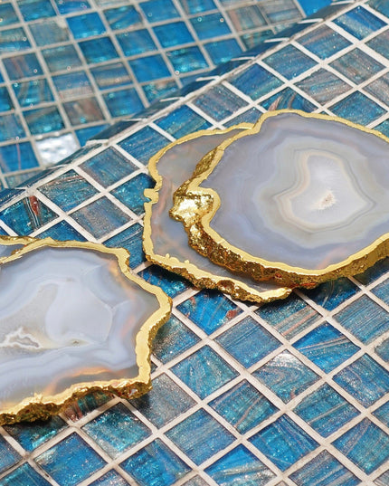 Gray Agate Coasters with Gold Rim on a Blue Mosaic Background