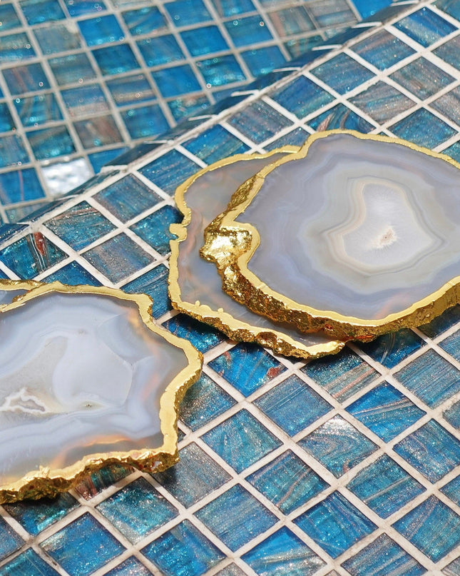 Gray Agate Coasters with Gold Rim on a Blue Mosaic Background