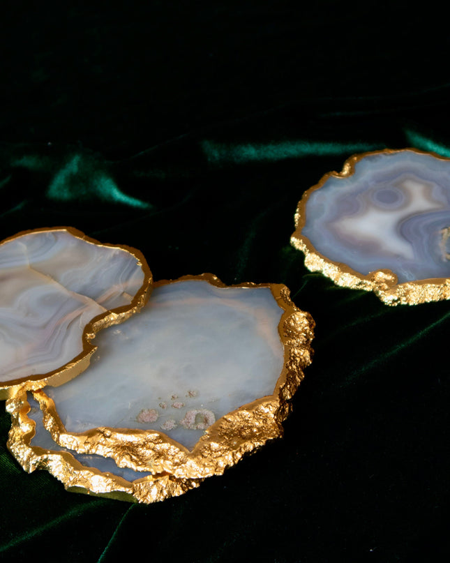 Agate coasters with gold edges on a dark background