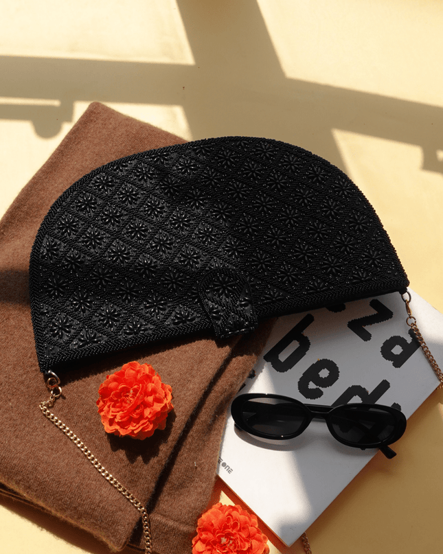 Black beaded Clutch with Strap with Sunglasses and a brown blanket