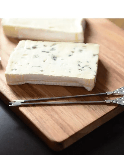 Set of 2 hammered silver Appetizer picks on a wooden cheese board.