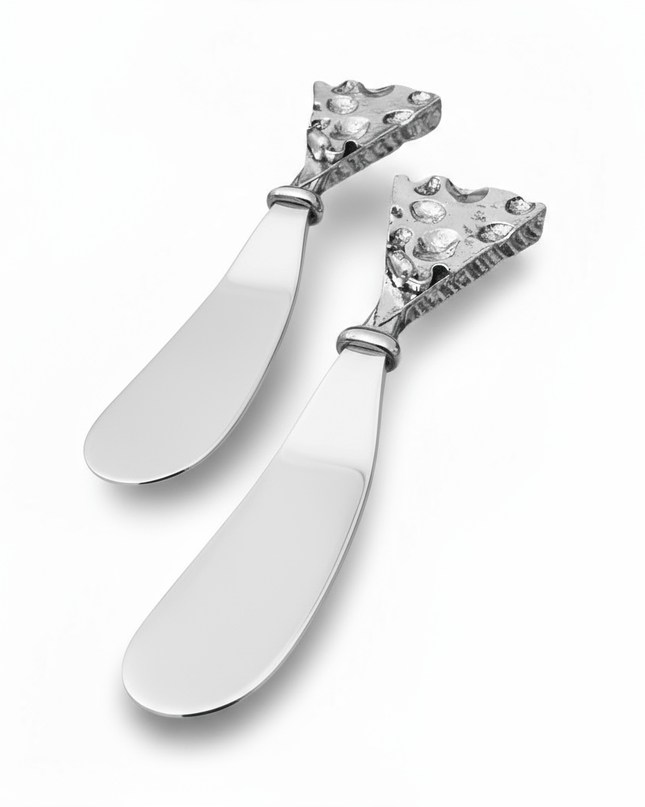 Two decorative hammered silver butter cheese knives with intricate designs on a white background