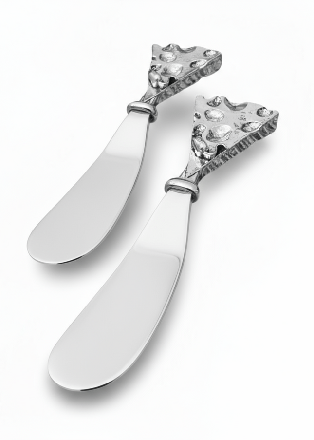 Two decorative hammered silver butter cheese knives with intricate designs on a white background
