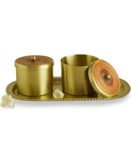 Set of gold brass containers with a decorative tray on a white background