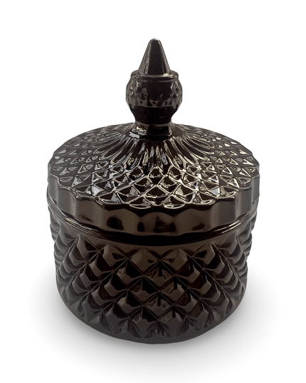 Decorative black glass jar with a prism-cut design and a small finial on a white background
