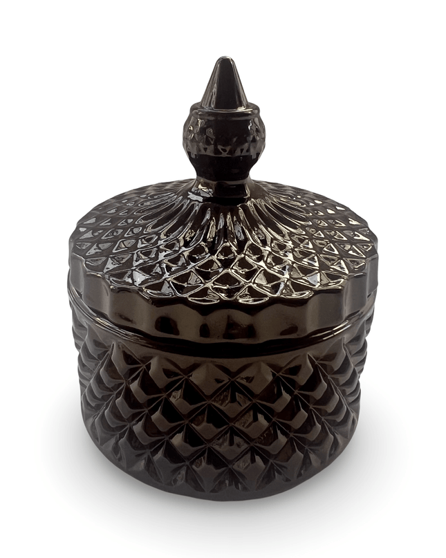 Decorative black glass jar with a prism-cut design and a small finial on a white background