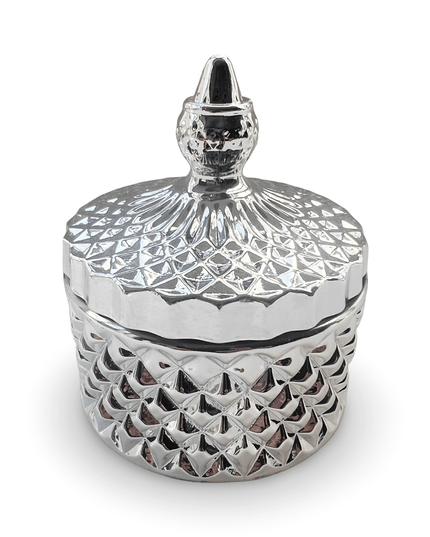 Decorative silver glass jar with a prism-cut design and a small finial on a white background