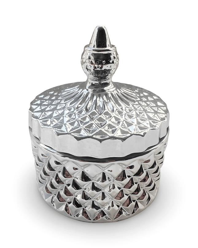 Decorative silver glass jar with a prism-cut design and a small finial on a white background