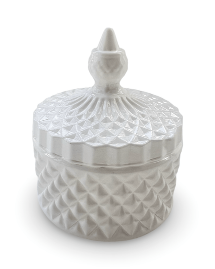 Decorative white glass jar with a prism-cut design and a small finial on a white background