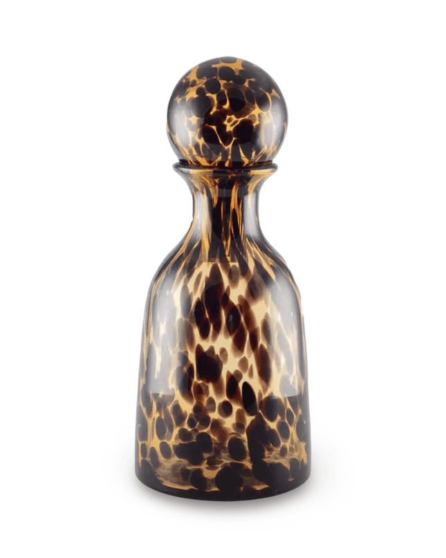 Leopard patterned bottle carafe with stopper on a white background