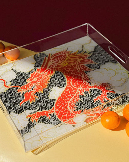Tray with a dragon design and mandarin oranges on a yellow surface
