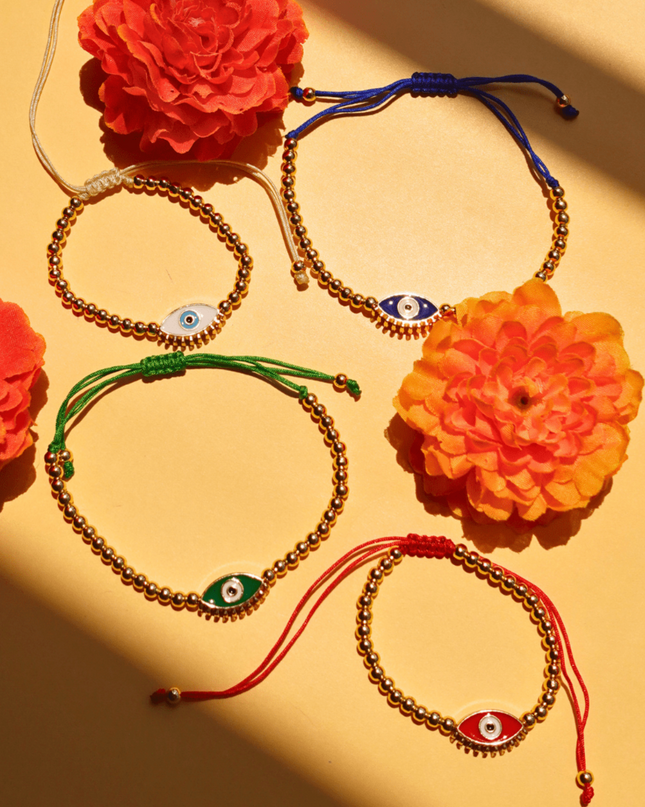 Beaded Evil Eye Bracelets on a Yellow Background