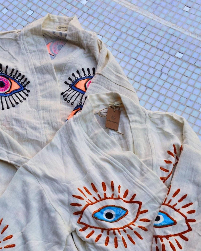 Light-Colored Robes With Evil Eye Designs