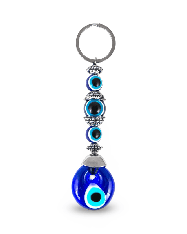Keychain with blue evil eye design on a white background