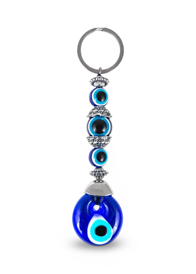 Keychain with blue evil eye design on a white background