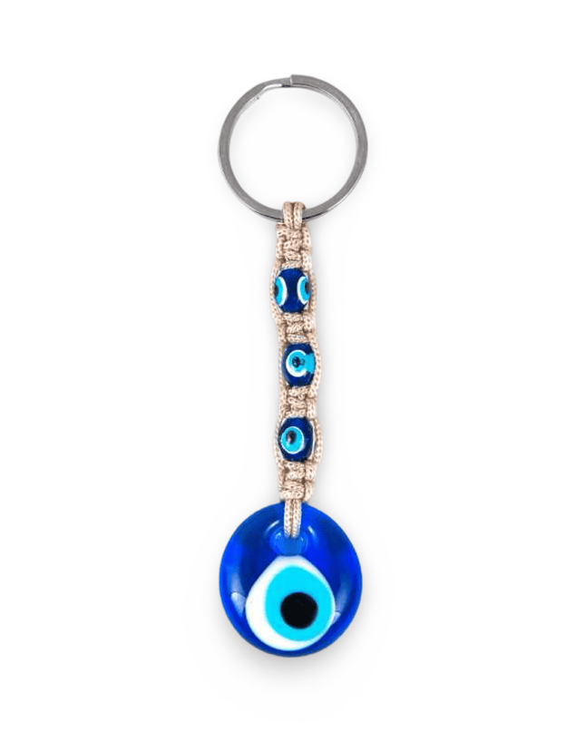 Keychain with blue evil eye design and beige macrame on a white background