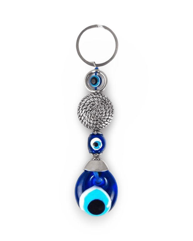 Keychain with blue evil eye design on a white background