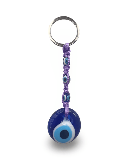 Keychain with blue evil eye charm and purple macrame on a white background