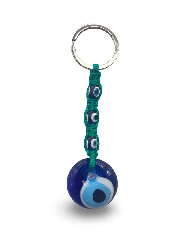 Keychain with blue evil eye charm with teal macrame on a white background