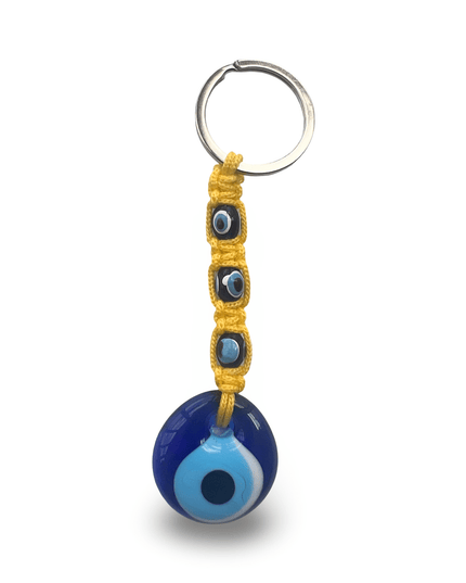 Keychain with blue evil eye charm and yellow macrame on a white background
