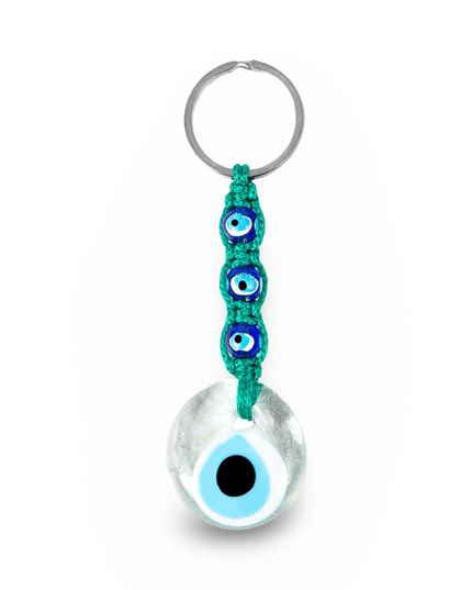 Keychain with an evil eye charm and green macrame on a white background