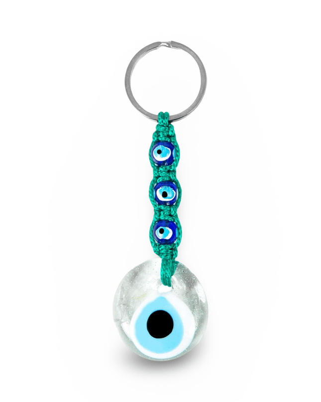 Keychain with an evil eye charm and green macrame on a white background