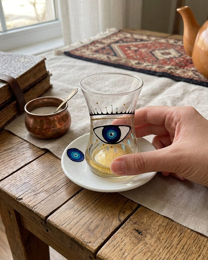 Hand holding a Big Eye Nazar teacup and saucer