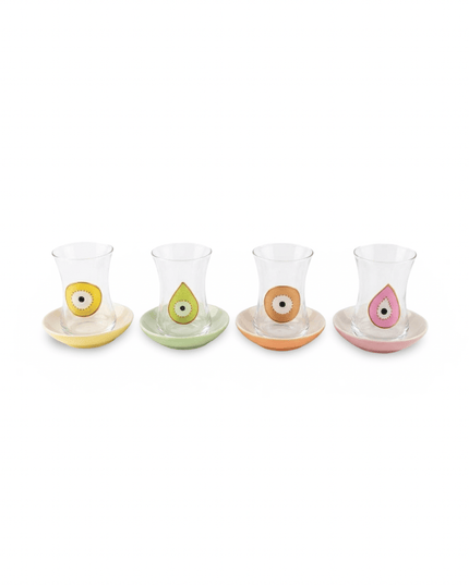 Naina evil eye tea set, clear glass teacups with hand-painted colorful evil eyes on pink, orange, yellow and lime green porcelain saucers