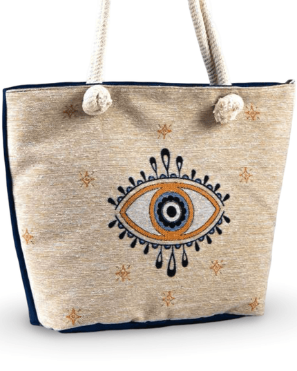 Beige tote bag with evil eye design and rope handles on a white background