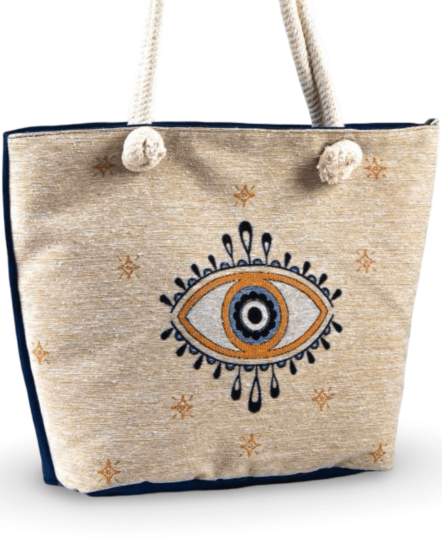 Beige tote bag with evil eye design and rope handles on a white background