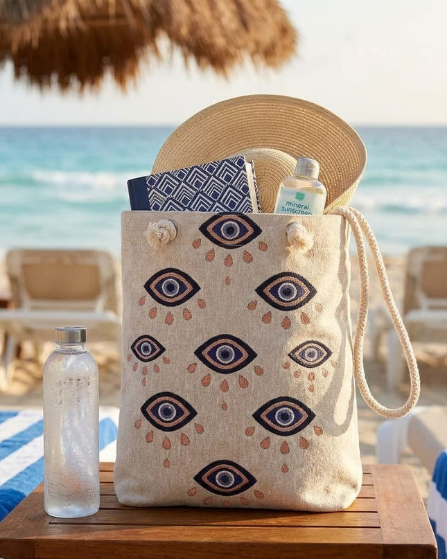 Casa Duniya Evil Eye Embroidered Canvas Tote Beige on a Beach Mat with Beach Essentials Medina Evil Eye Canvas Beach Bag