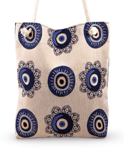 Canvas tote bag with blue and black evil eye pattern on a white background