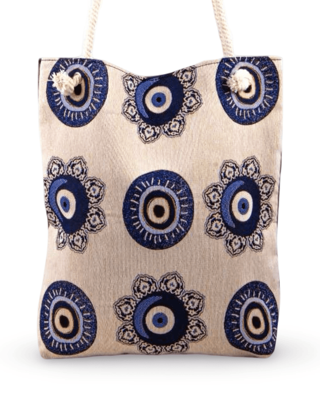 Canvas tote bag with blue and black evil eye pattern on a white background