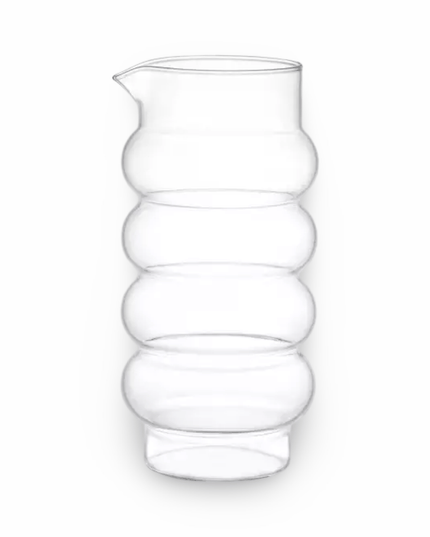 Clear glass pitcher with a ribbed  bubble design on a white background