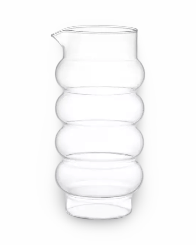 Clear glass pitcher with a ribbed  bubble design on a white background