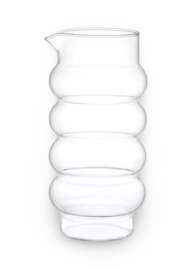 Clear glass pitcher with a ribbed  bubble design on a white background