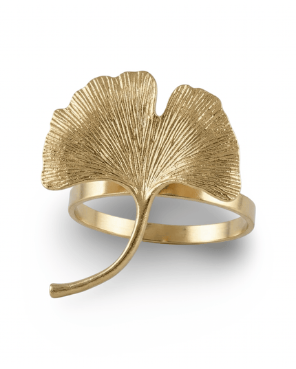 Close-up of a gold ginkgo leaf napkin ring with a textured, veined leaf and curved stem