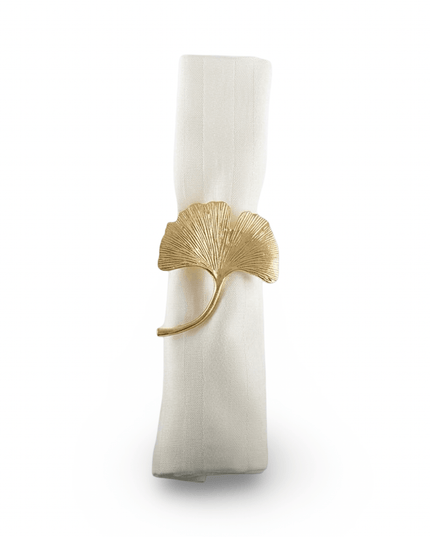 Gold ginkgo leaf napkin ring holding a rolled white linen napkin