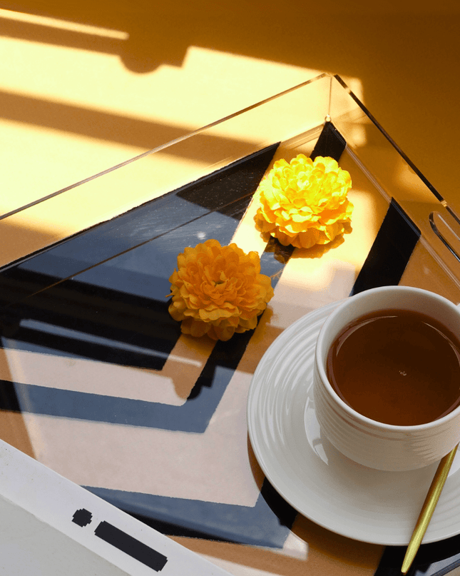 Cup of tea with a saucer on a hand-painted acrylic tray with yellow flowers