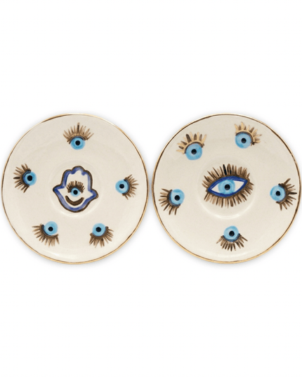 Sahar white ceramic dessert plates with gold rims, one with a blue and gold evil eye and one with a hamsa hand