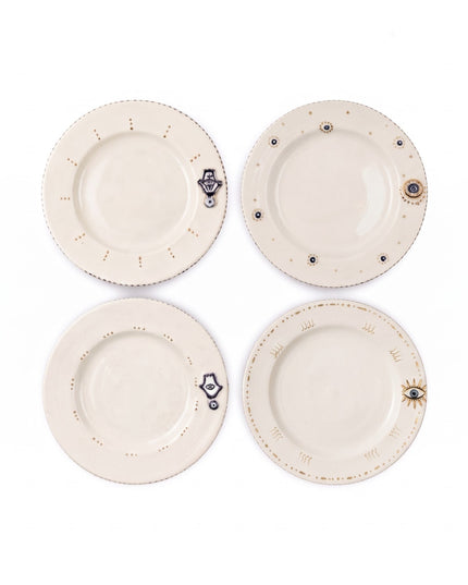 Four Tala hand-painted evil eye and hamsa dessert plates seen from above, each with a different small motif