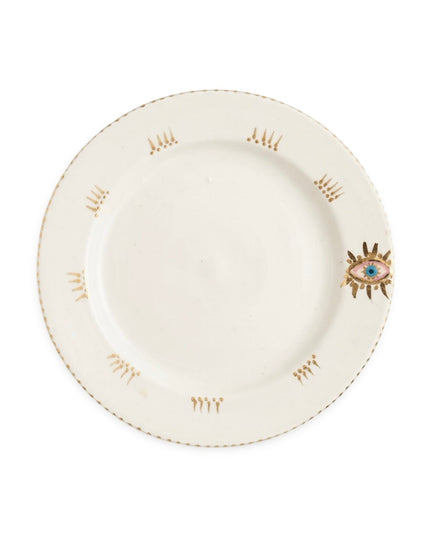 Tala cream ceramic dessert plate with gold-dotted rim and a hand-painted evil eye and gold lashes on the edge